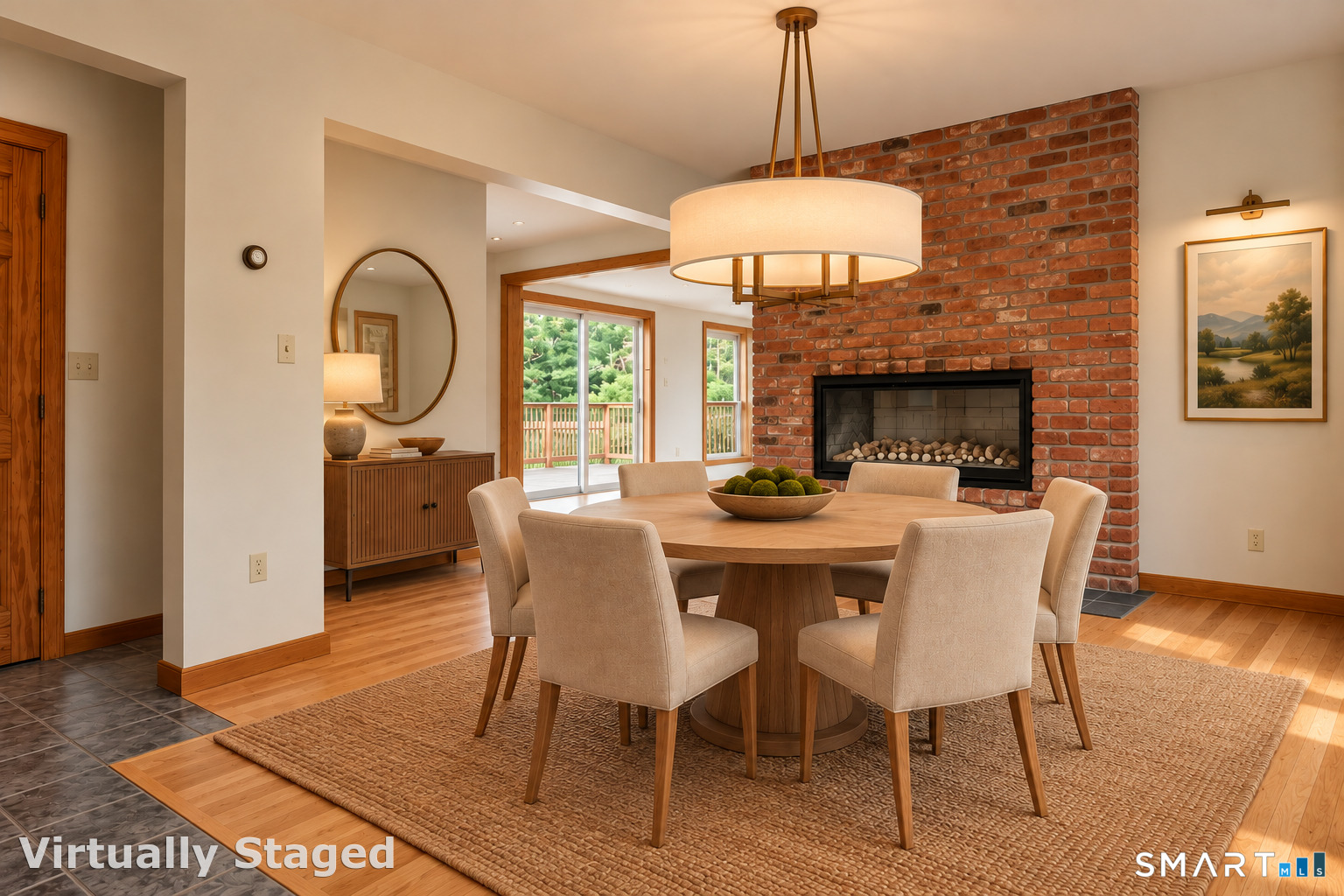 Virtually staged dining room with a round table, brick fireplace, and sliding glass doors.
