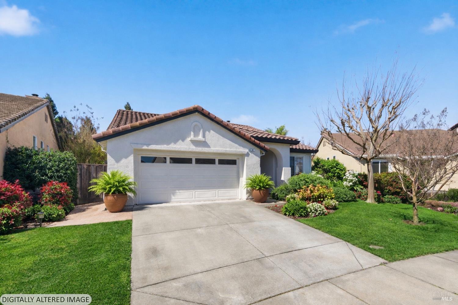 Single-story stucco home with a double garage, terracotta tile roof, and landscaped front yard.