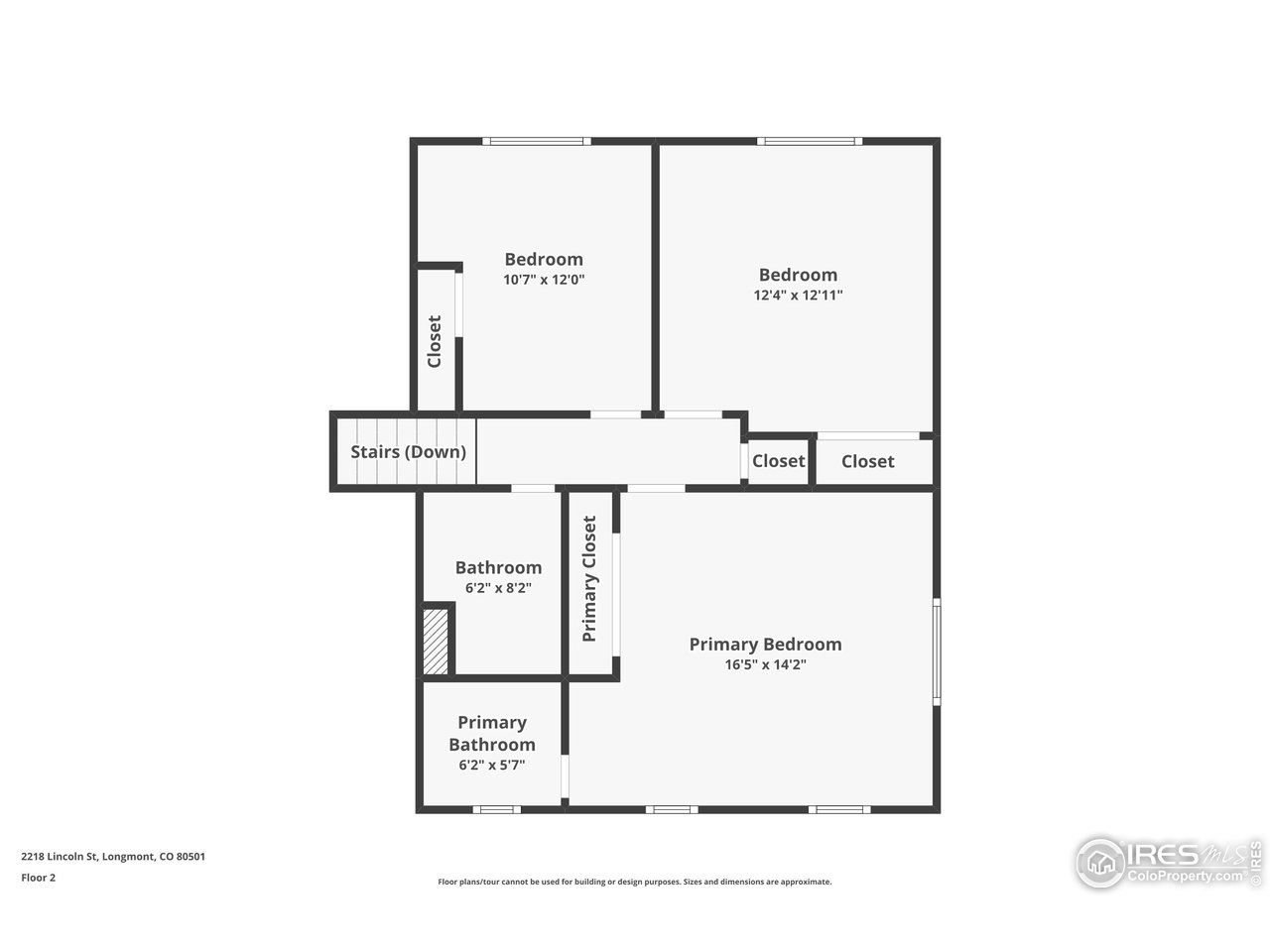 Second-floor plan showing three bedrooms, two bathrooms, closets, and stairs down.