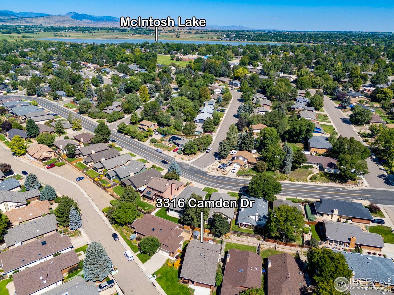 Aerial neighborhood view of 3316 Camden Dr, with McIntosh Lake and distant mountains beyond.