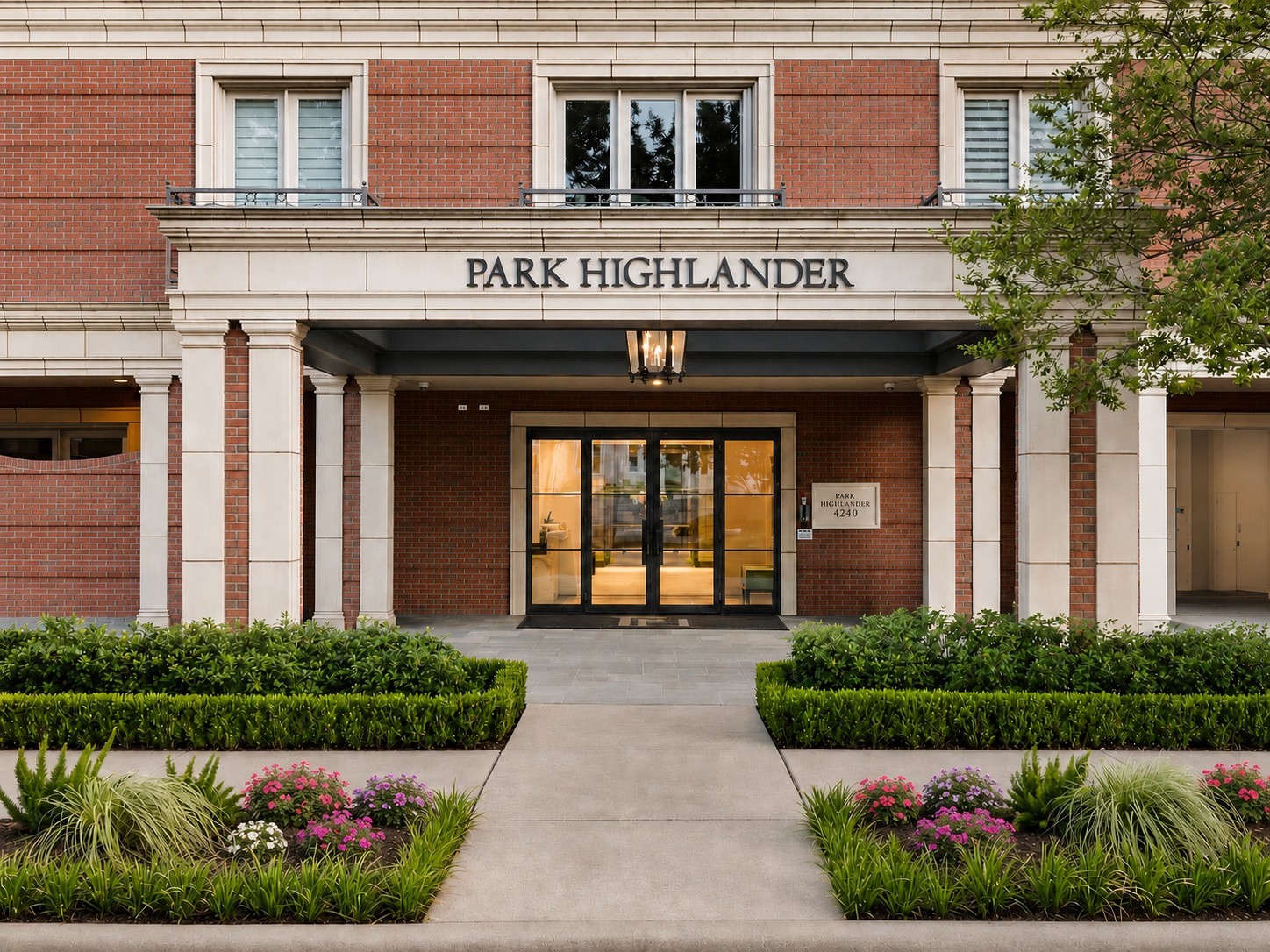 Park Highlander entrance with red-brick facade, stone columns, and landscaped walkway.