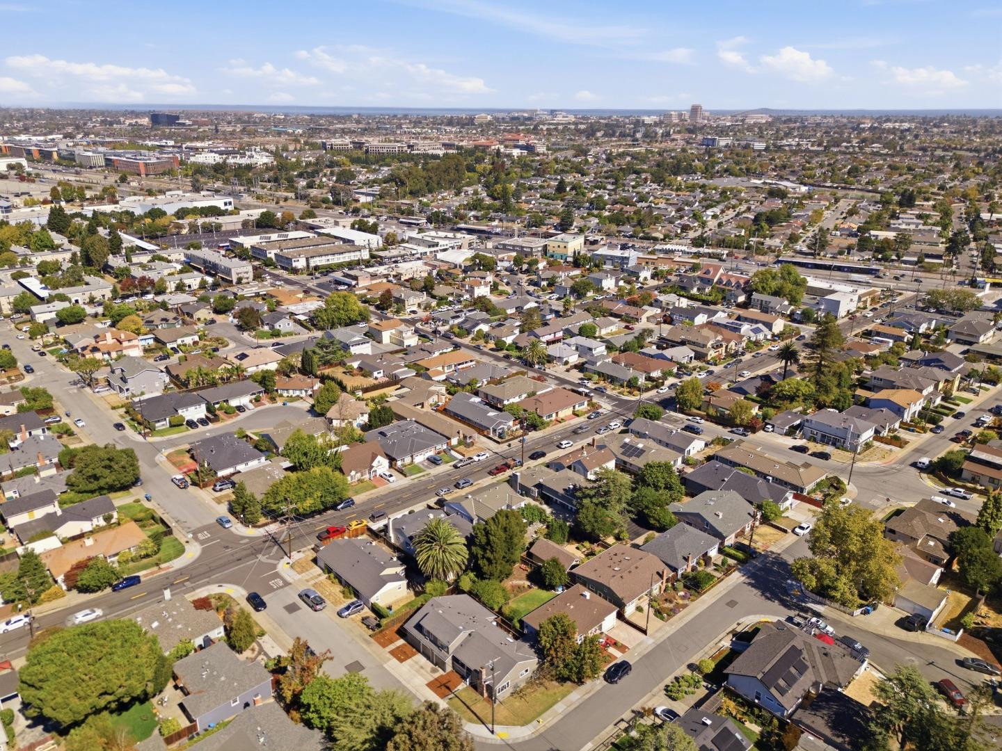 Aerial view of a San Mateo neighborhood with homes, roads, and commercial buildings.