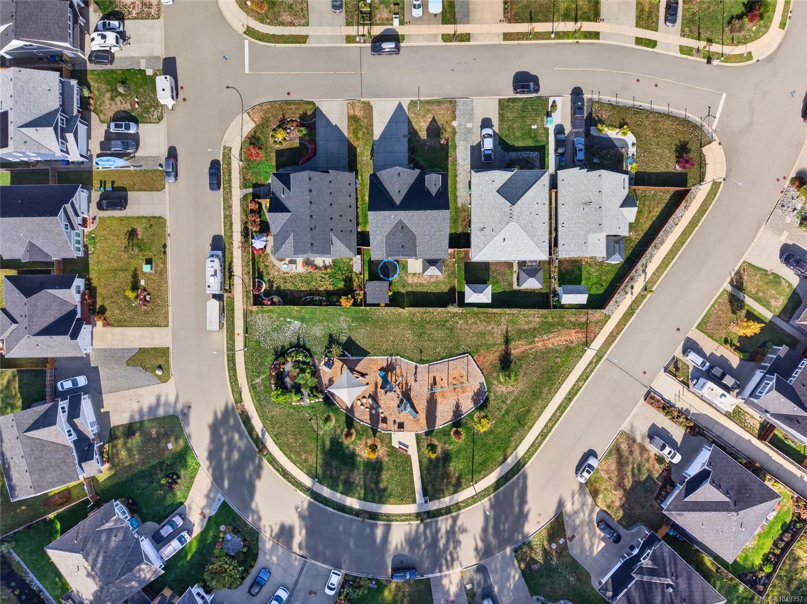Aerial view of homes on a cul-de-sac, with landscaped yards and a playground.