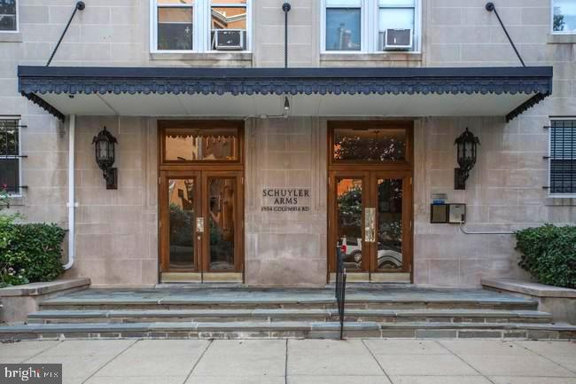 Schuyler Arms entrance with a wide awning, twin wood-and-glass doors, and stone steps.