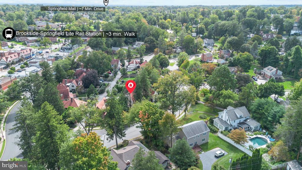 Aerial view of a tree-lined Springfield neighborhood, with a red pin marking a home near a backyard pool.