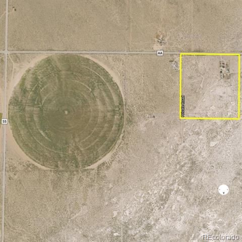 Aerial view of a rural parcel outlined in yellow beside County Road AA and a circular farm field.