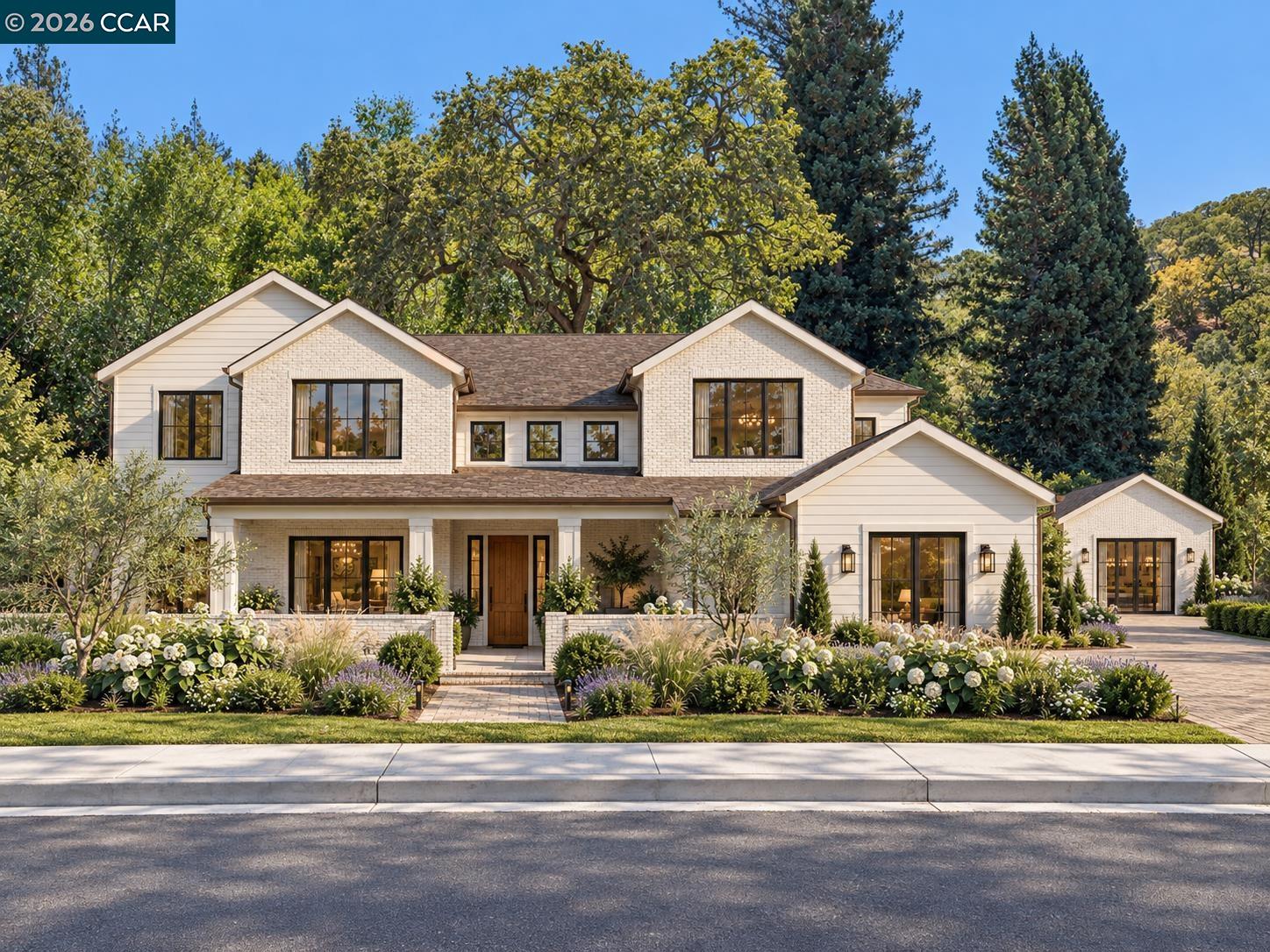 Two-story white house with dark-framed windows, a landscaped garden, and mature trees.