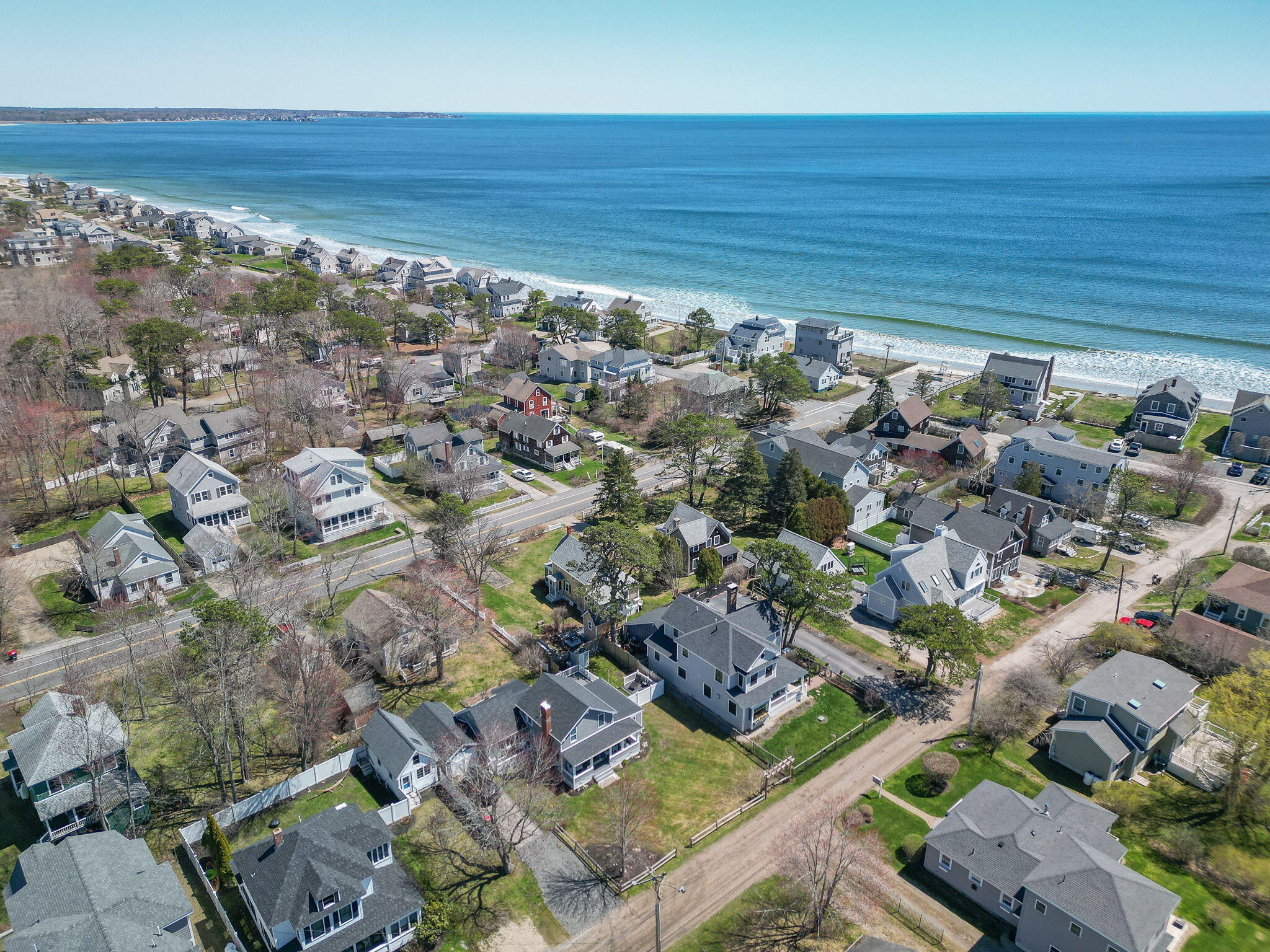 Aerial view of coastal homes beside a beach and ocean in Wells, Maine.