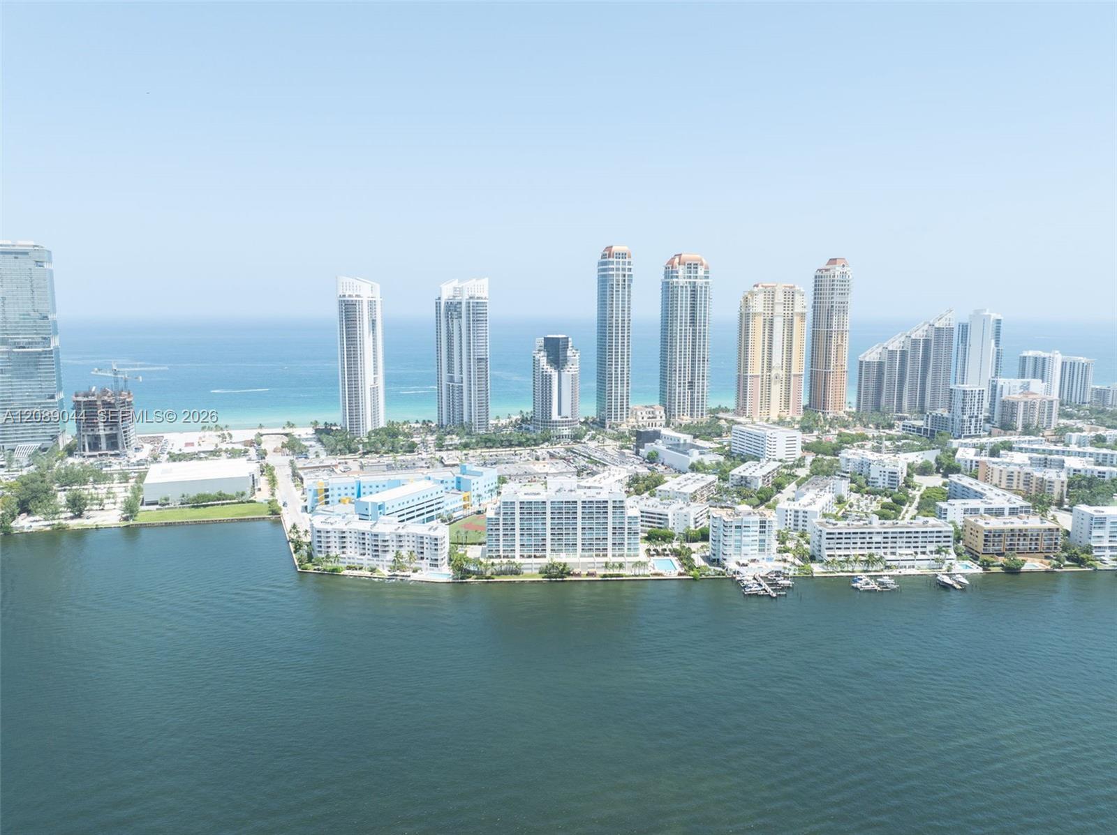 Sunny Isles Beach skyline along the ocean, with waterfront residences and bay in the foreground.