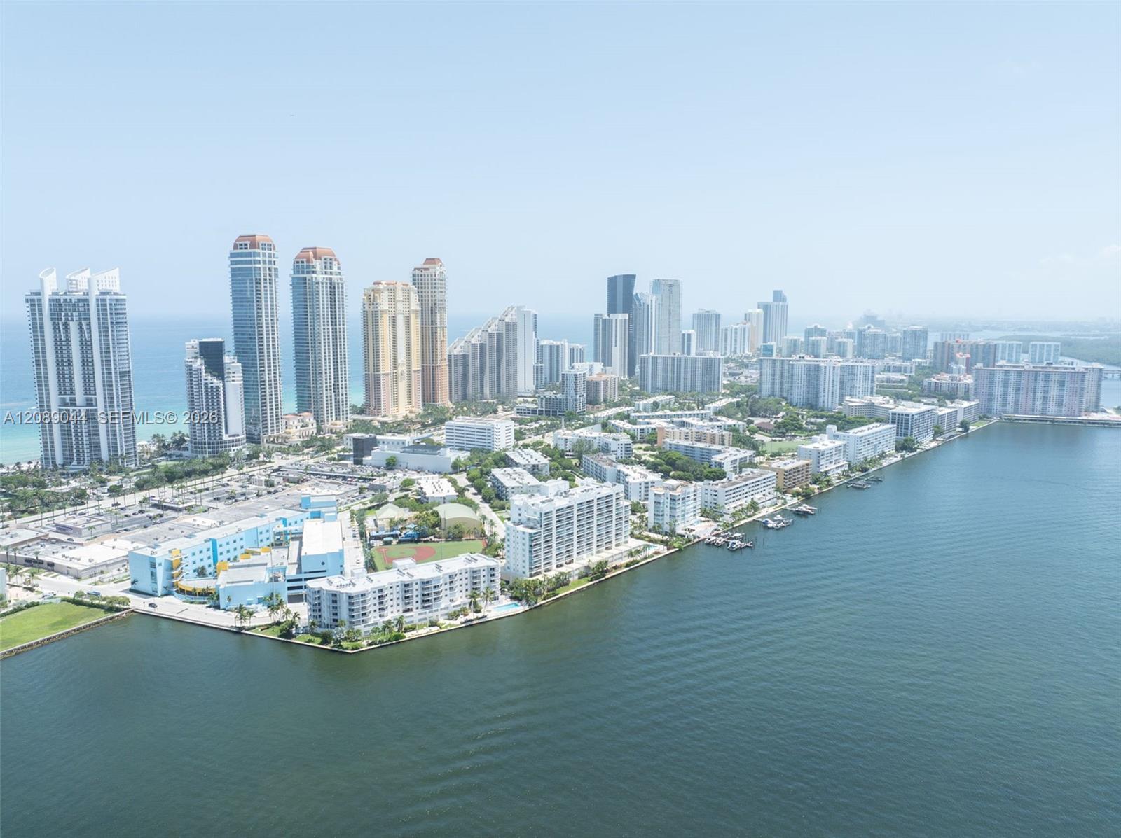 Aerial view of Sunny Isles Beach high-rises between the ocean and Intracoastal Waterway.