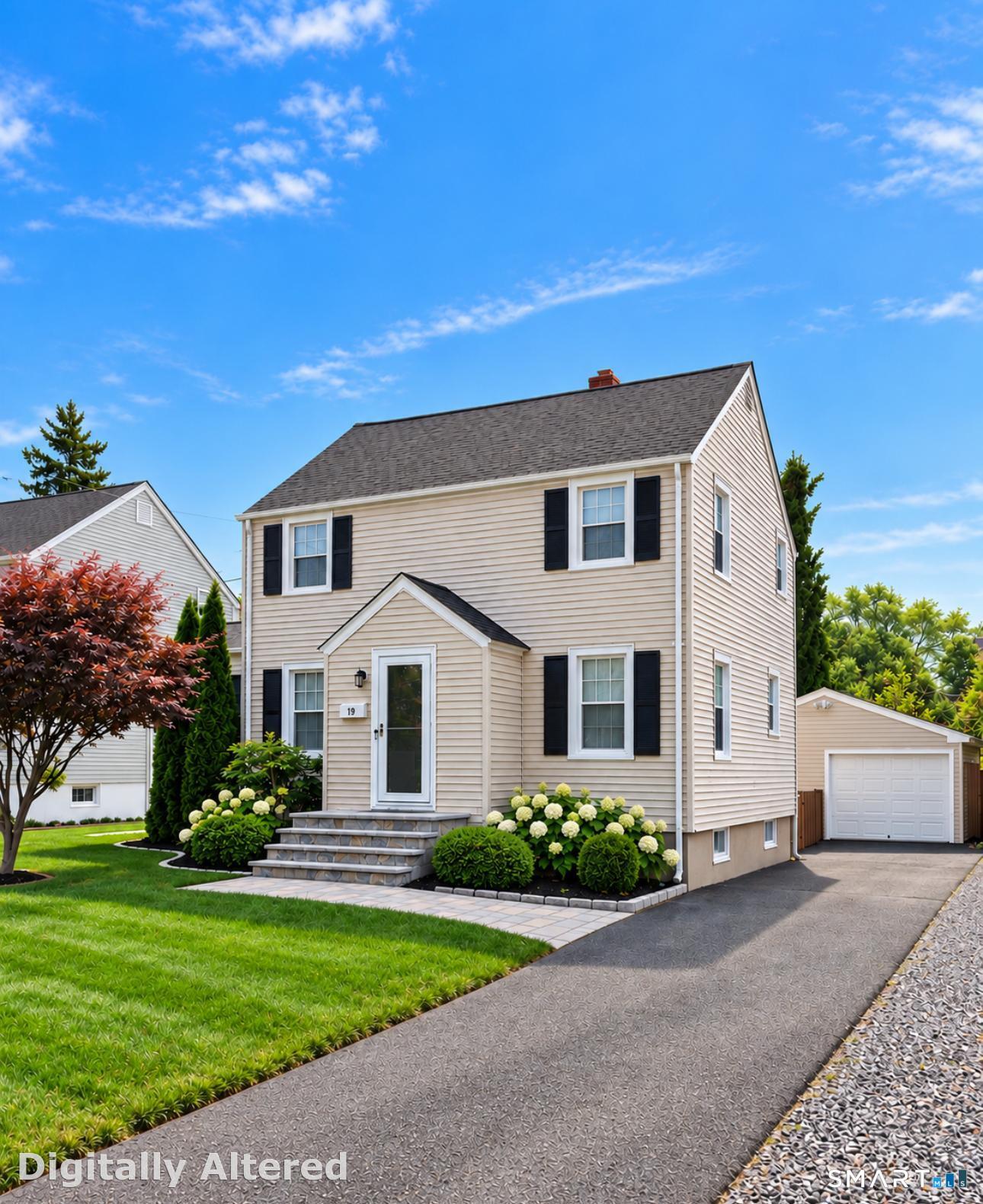 Two-story beige house with black shutters, landscaped front yard, and detached garage.