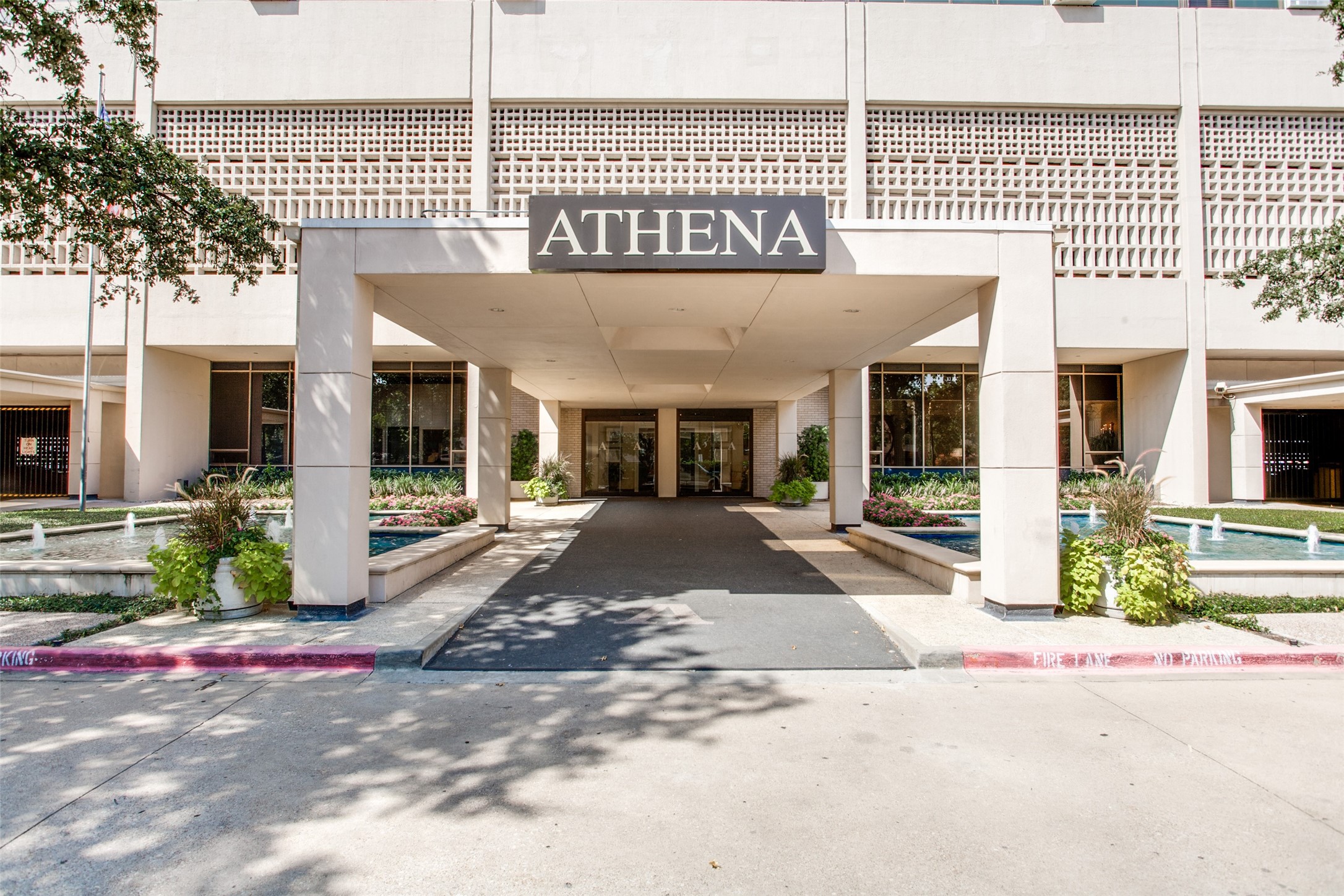 Athena building entrance with a broad canopy and fountain pools on either side.