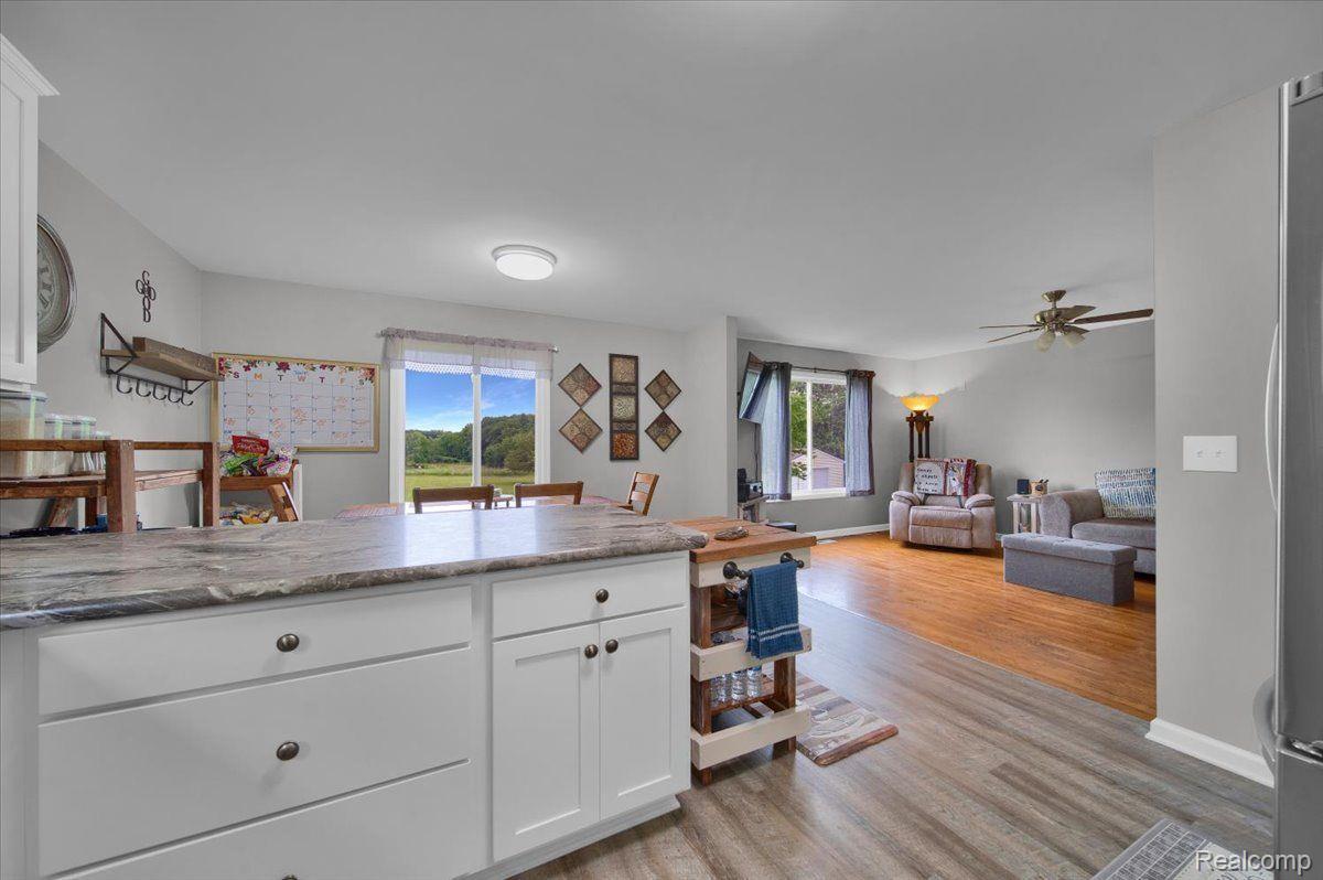 Open kitchen with a stone countertop overlooking the dining and living area.