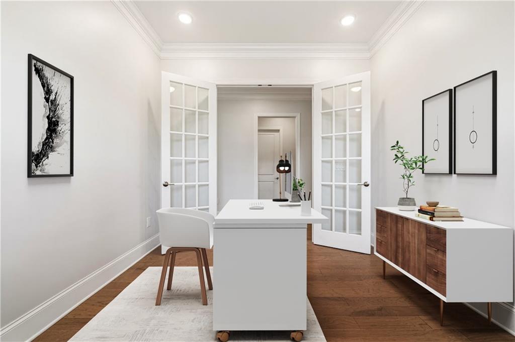 Staged home office with a white desk, glass-paneled French doors, and a wood-and-white cabinet.