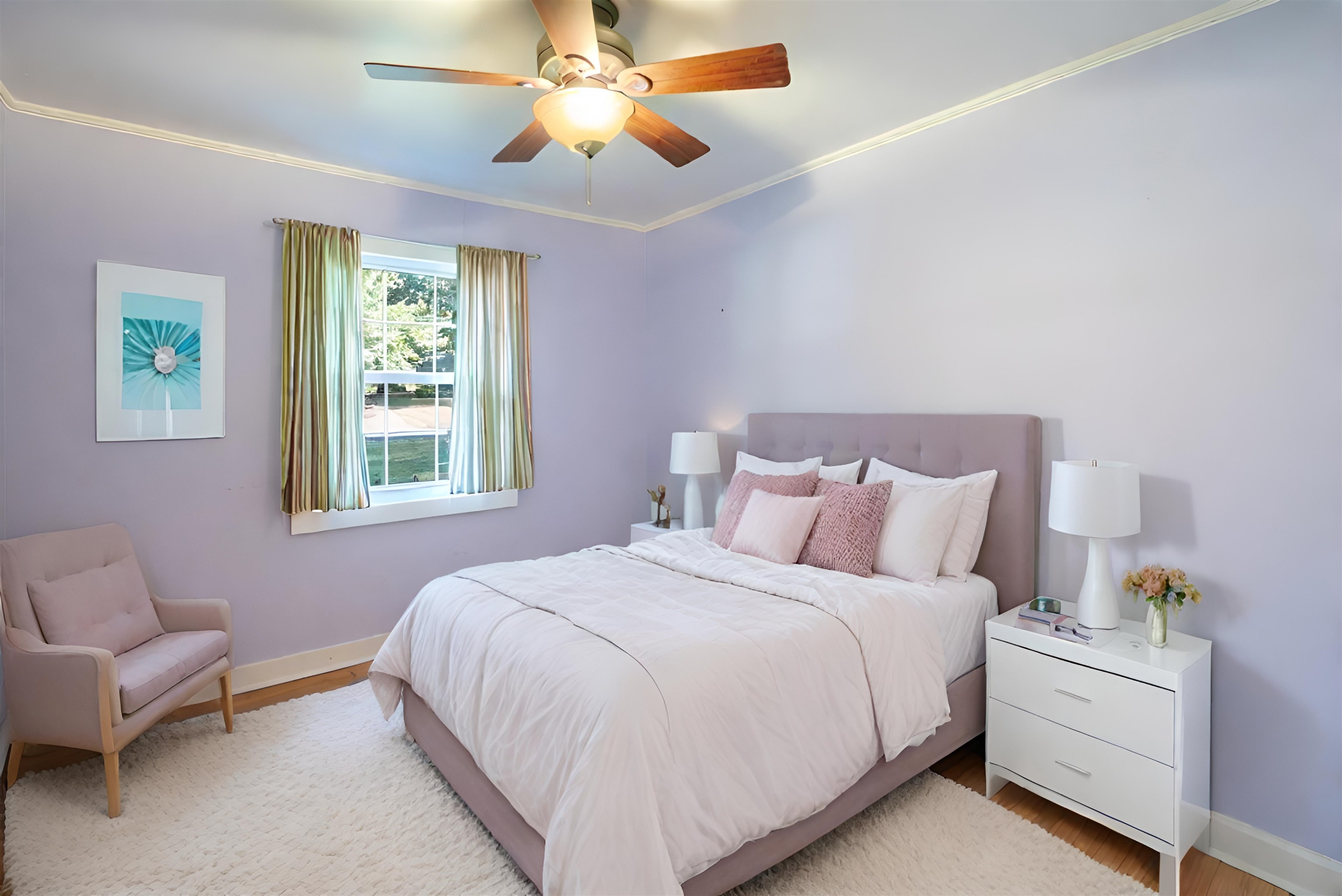 Bedroom with a pink upholstered bed, lavender walls, curtained window, and ceiling fan.