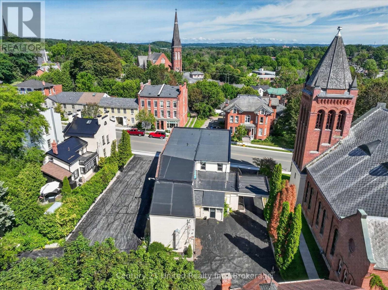 Aerial view of 135 Walton Street among downtown buildings, with red-brick church towers nearby.