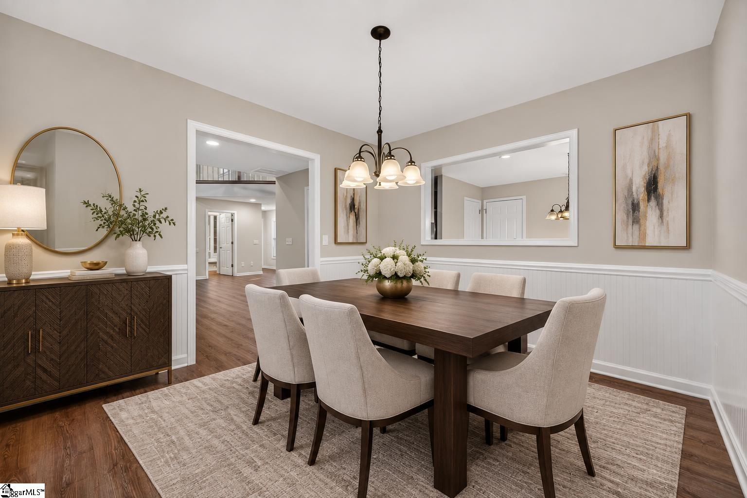 Dining room with a dark wood table, six upholstered chairs, and a chandelier.