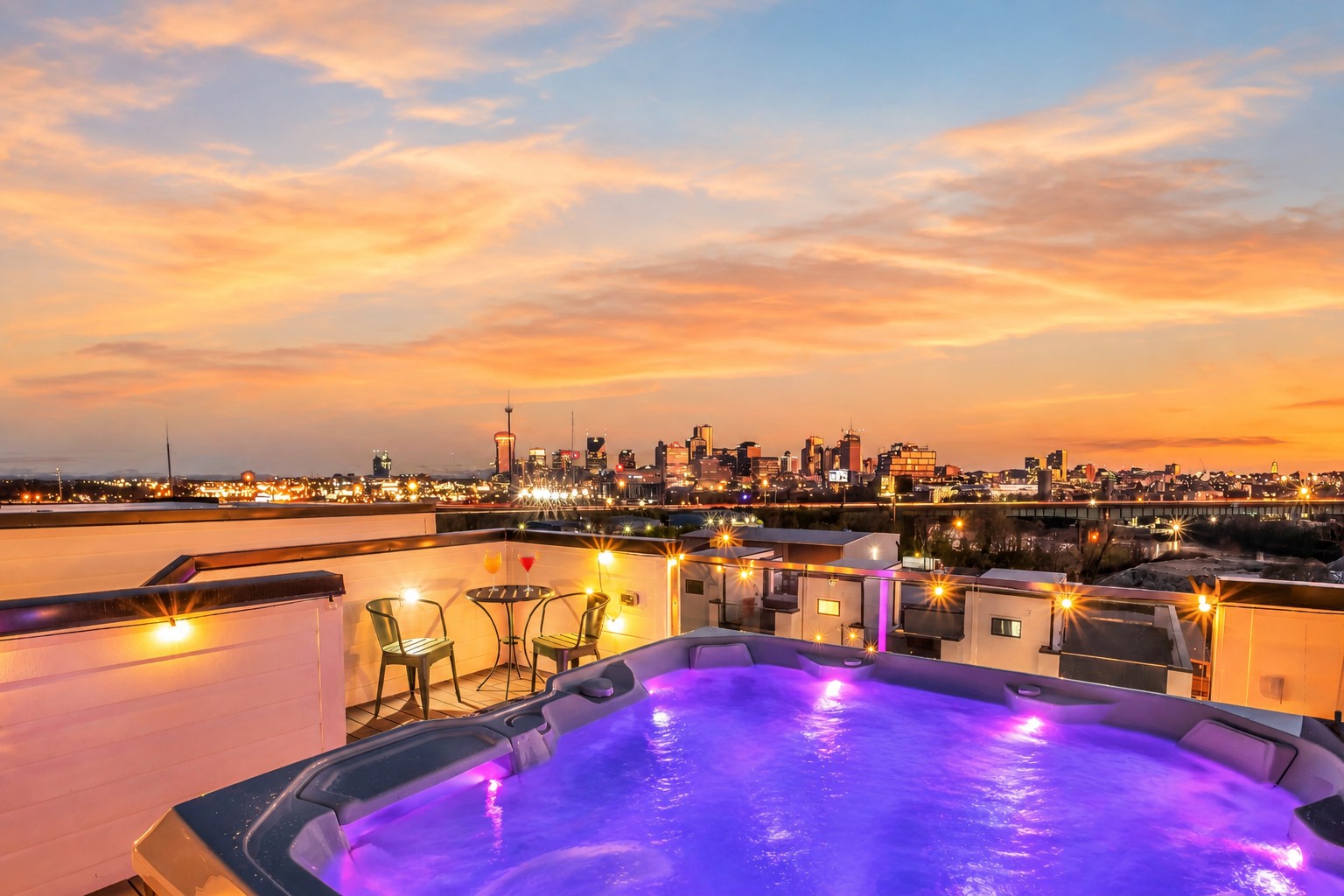 Rooftop hot tub and dining area overlooking the Nashville skyline at dusk.