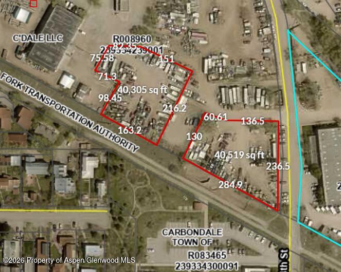 Aerial view of two outlined yard-storage parcels beside a transportation corridor in Carbondale.