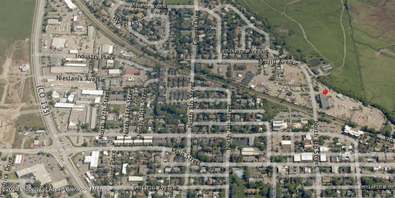 Aerial view of the Merrill Avenue neighborhood, with a red pin marking the property among streets and buildings.