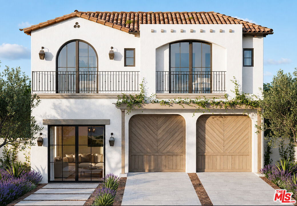 Two-story white stucco home with arched windows, wooden double garage doors, and a landscaped entry.