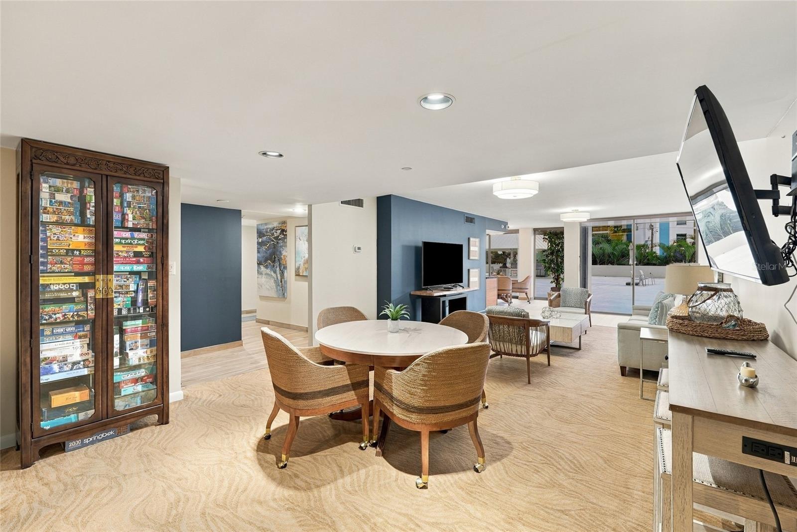 Furnished living and dining area with a blue accent wall and sliding doors to a patio.