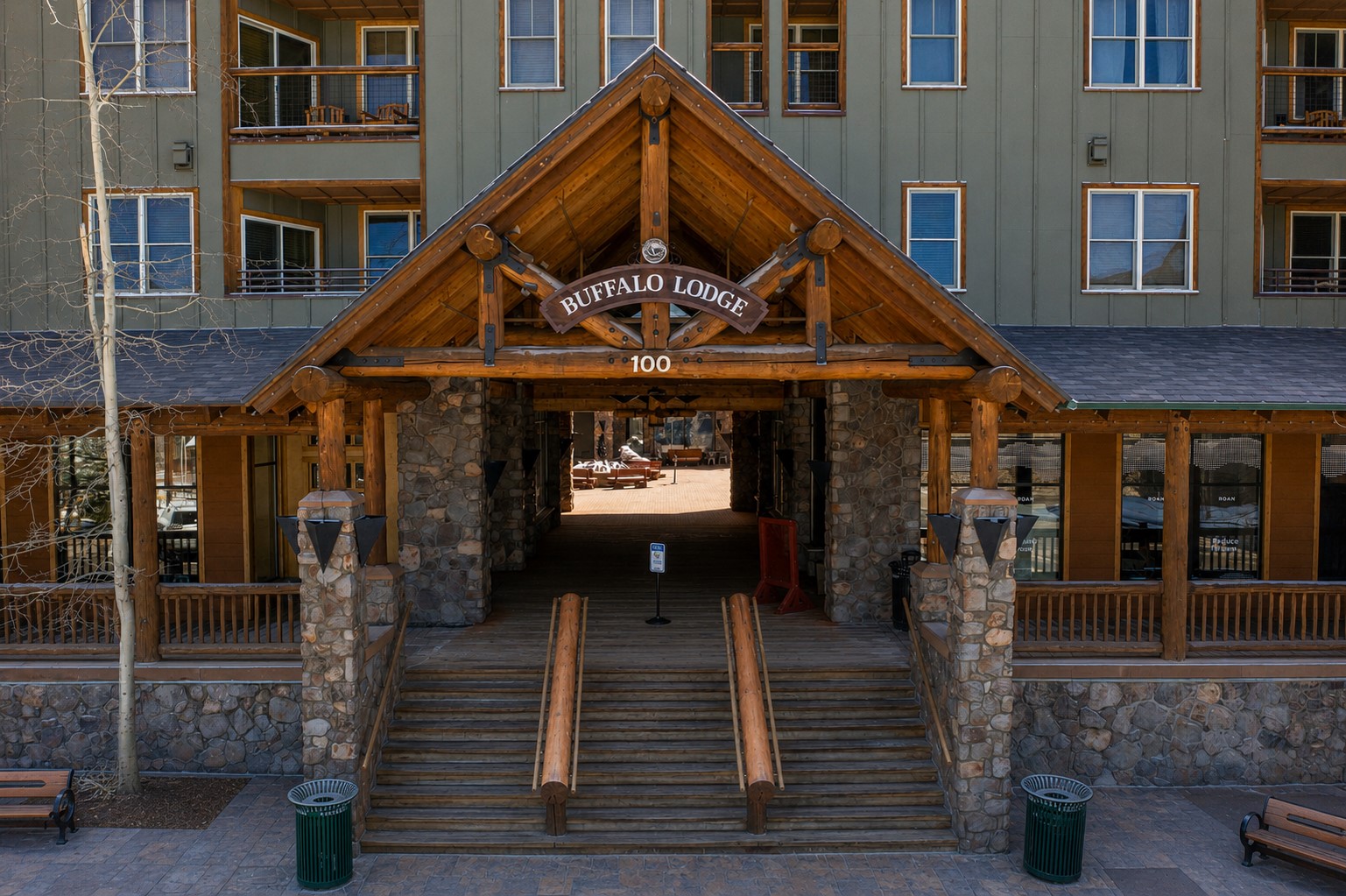 Buffalo Lodge entrance with a timber gable, stone pillars, and broad staircase.
