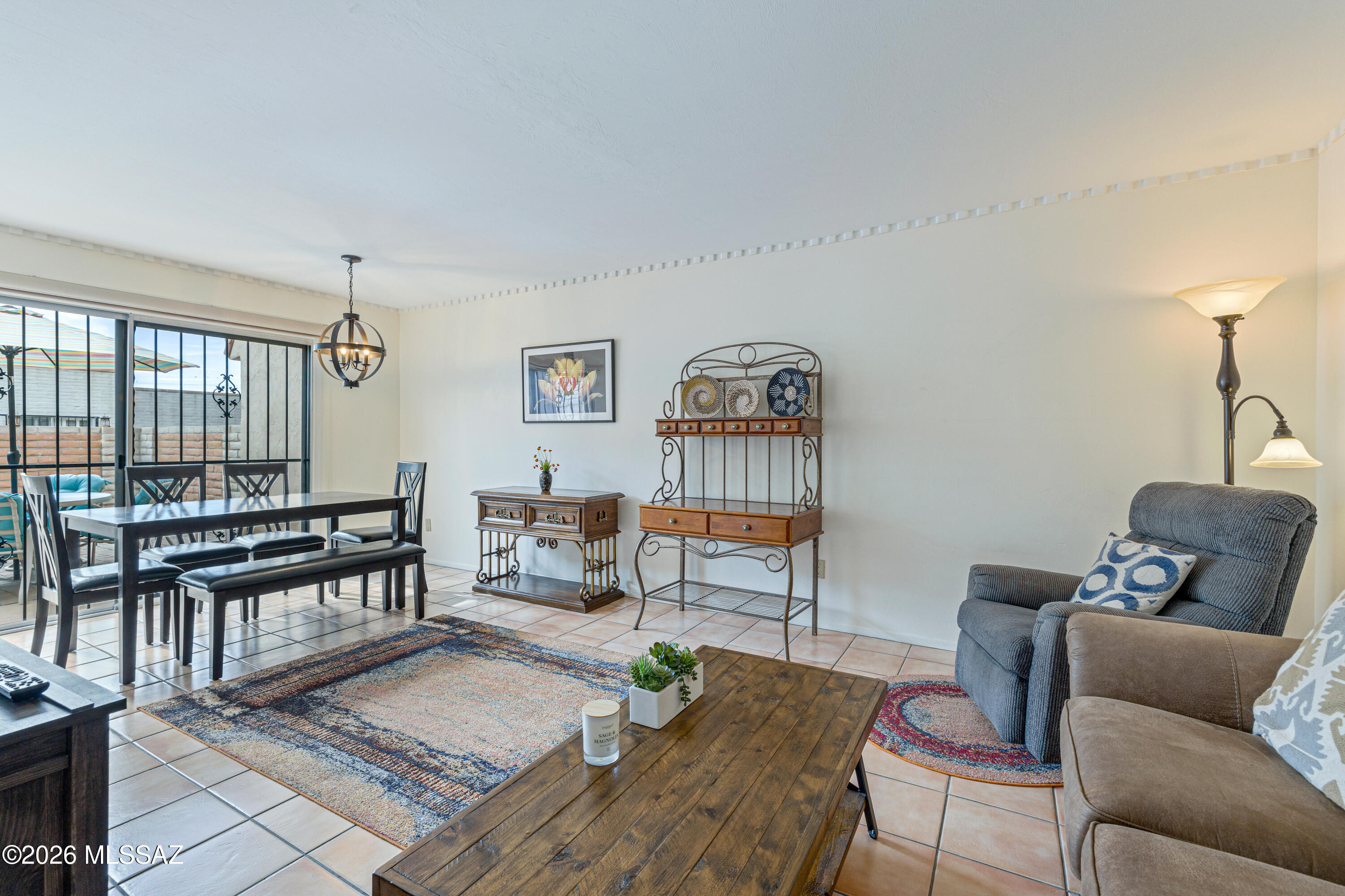 Furnished living and dining room with a gray recliner and sliding glass doors to a patio.