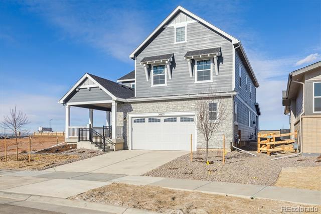 Gray two-story house with stone accents, a double garage, and a covered front porch.