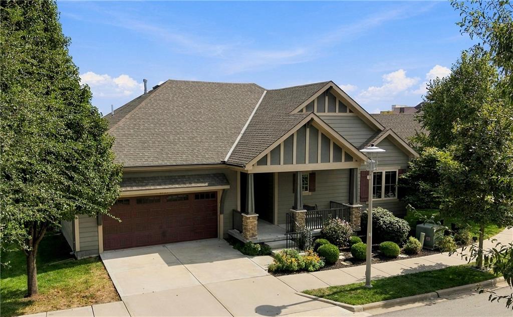 Single-story home with a gabled roof, covered porch, and attached two-car garage.
