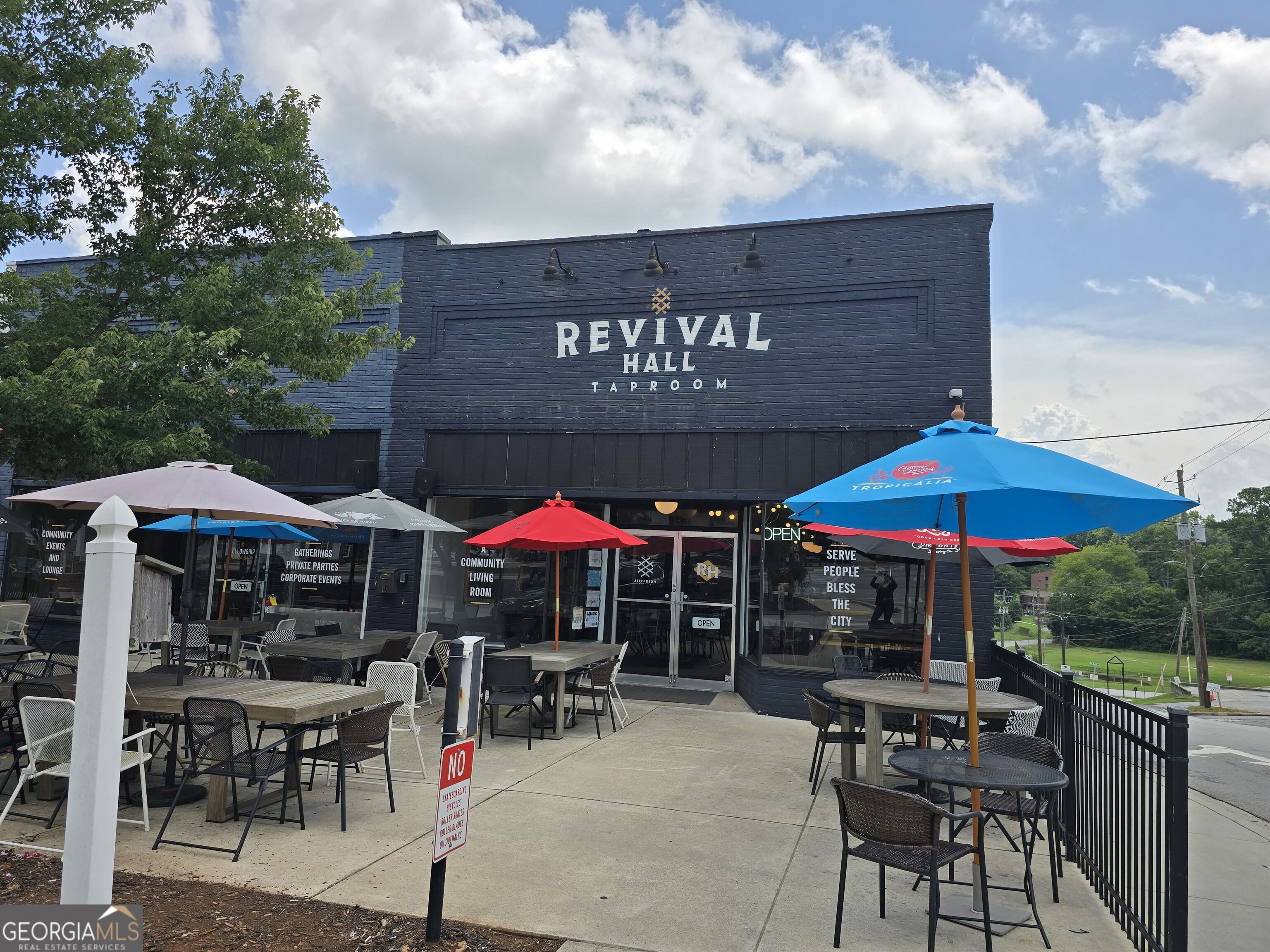 Revival Hall Taproom with a spacious outdoor patio and colorful umbrellas.