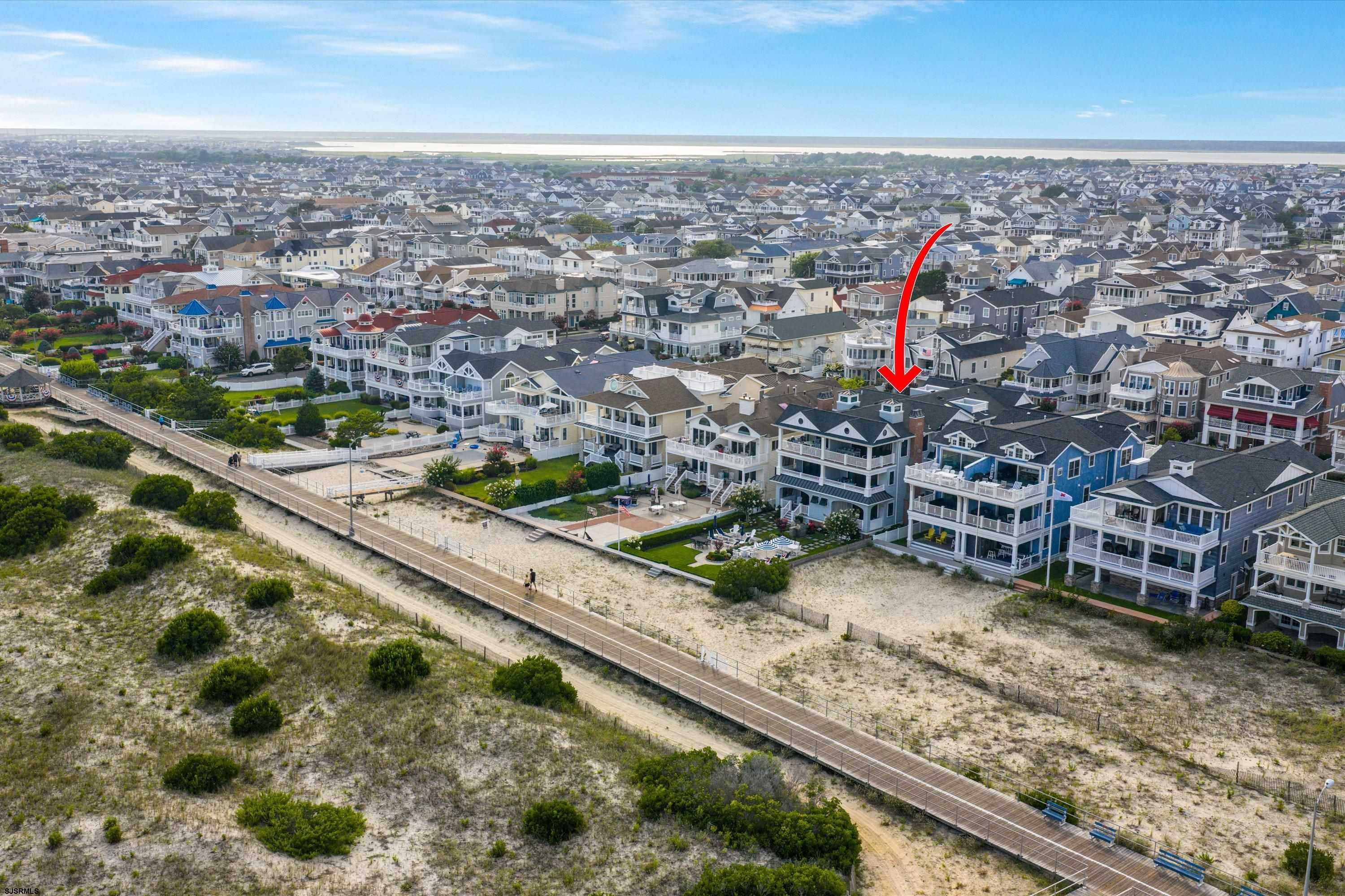 Aerial view of marked coastal home beside beach and boardwalk in Ocean City.