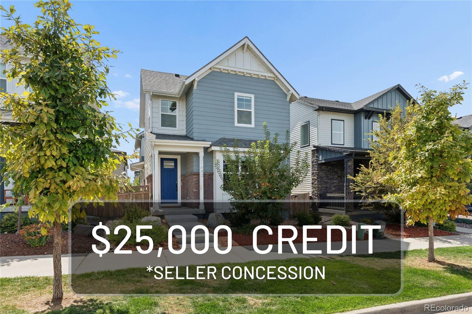 Blue two-story home with a blue front door and a $25,000 seller concession banner.