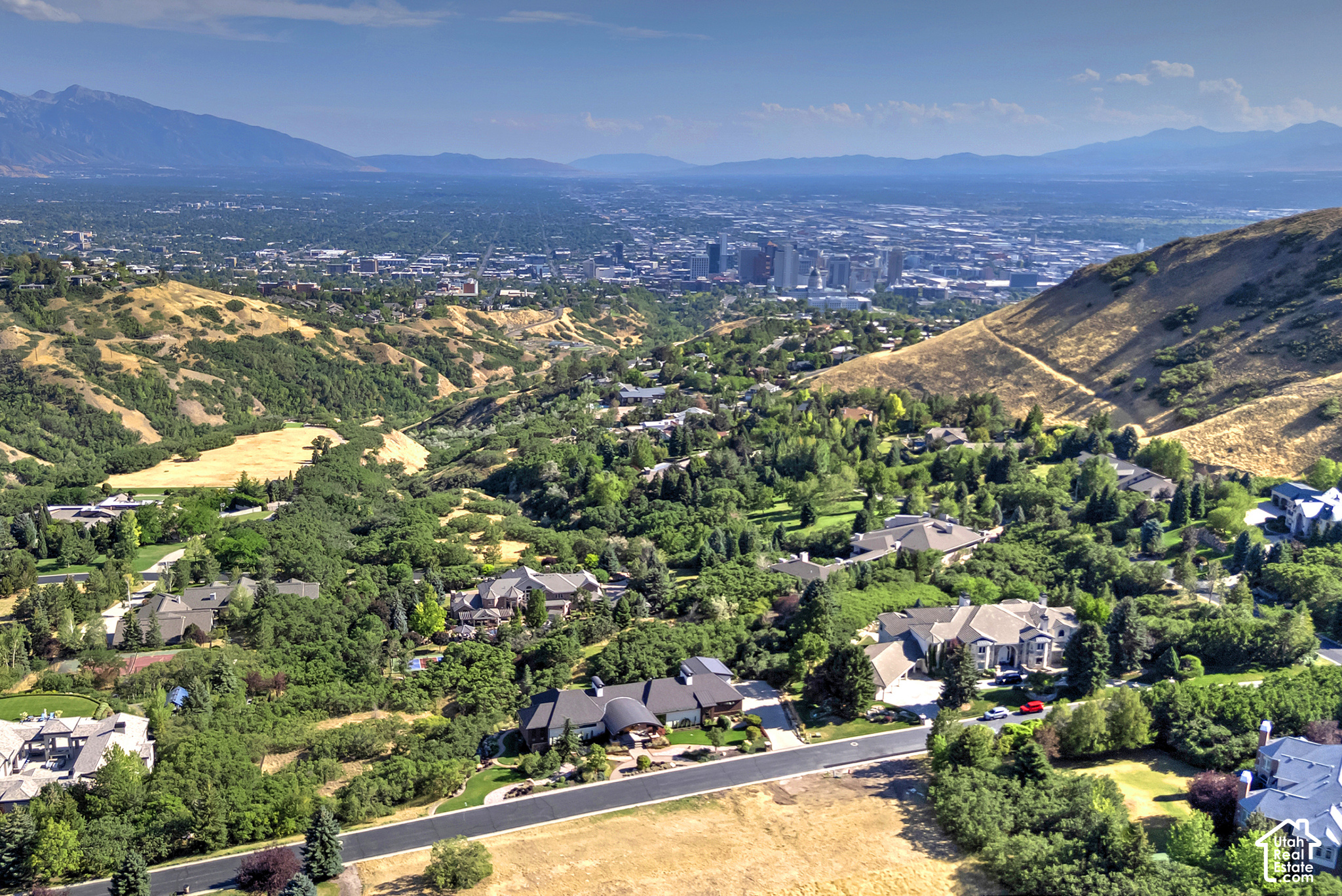 Aerial view of foothill homes overlooking downtown Salt Lake City and the surrounding mountains.