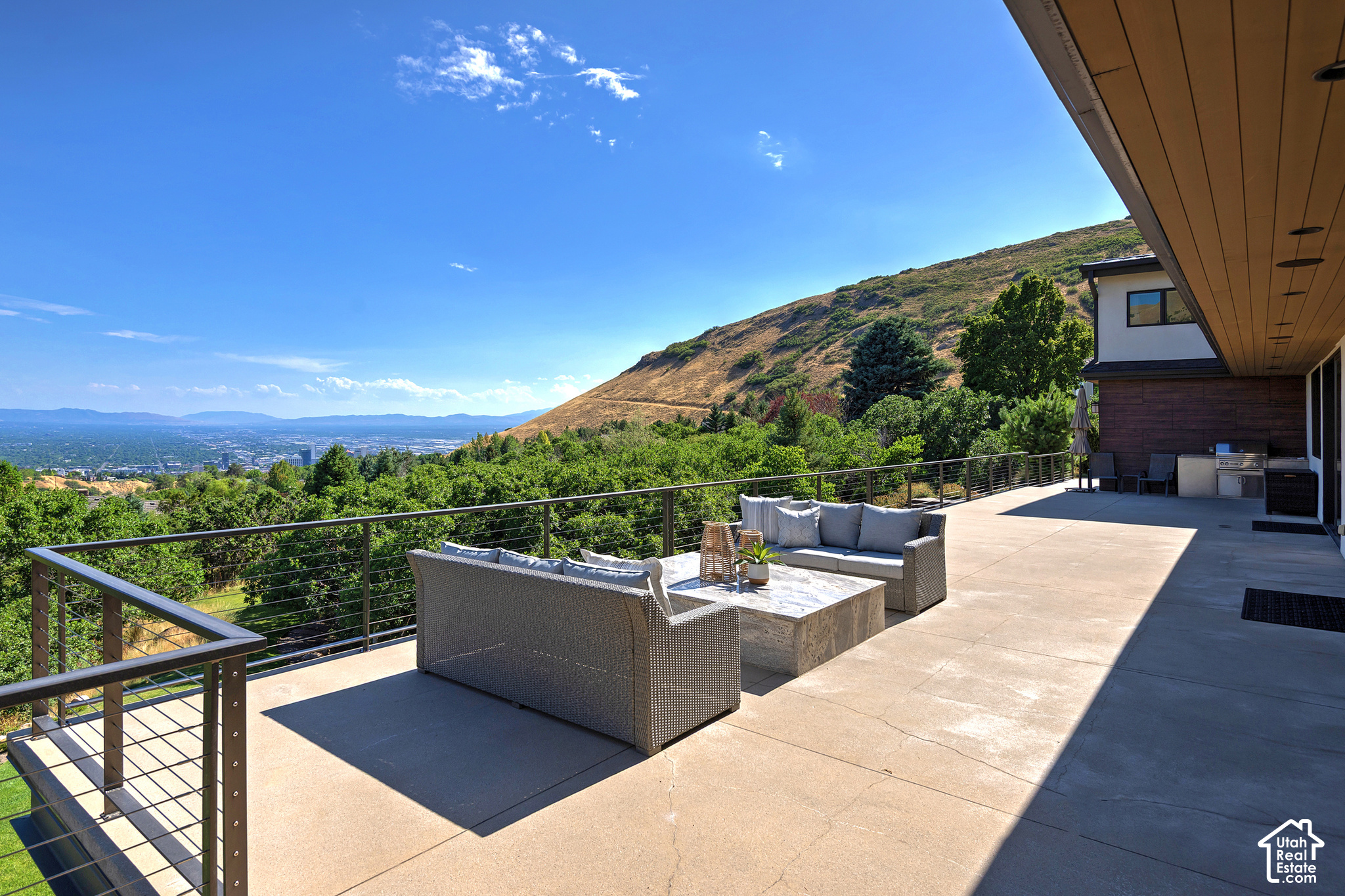 Furnished terrace with outdoor kitchen, hillside and Salt Lake City views.