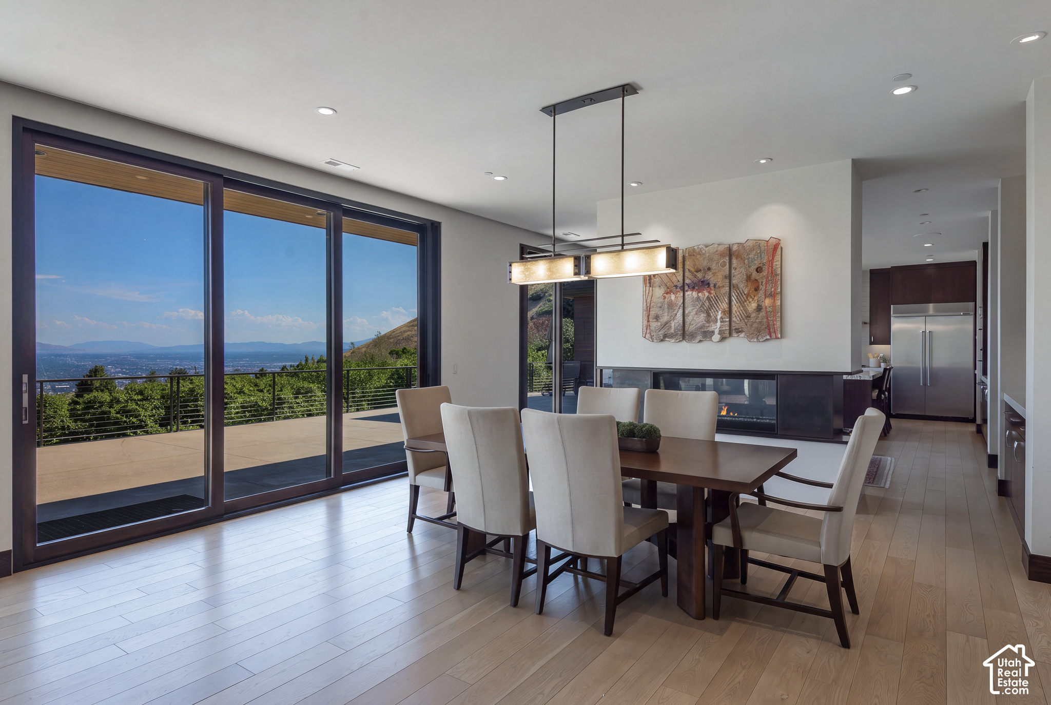 Dining room with sliding glass doors overlooking the valley and distant mountains.