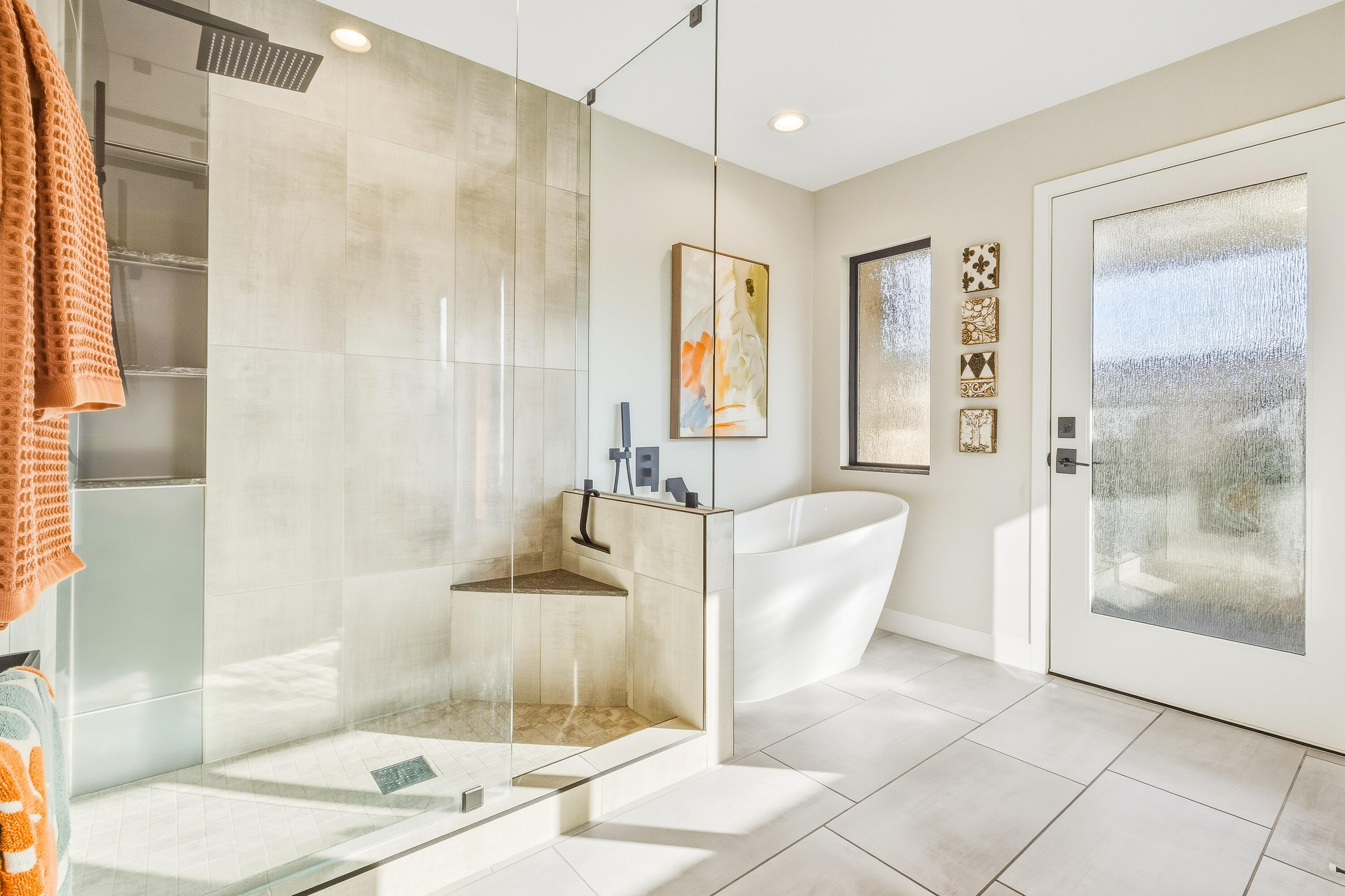 Modern bathroom with a glass walk-in shower and freestanding soaking tub.
