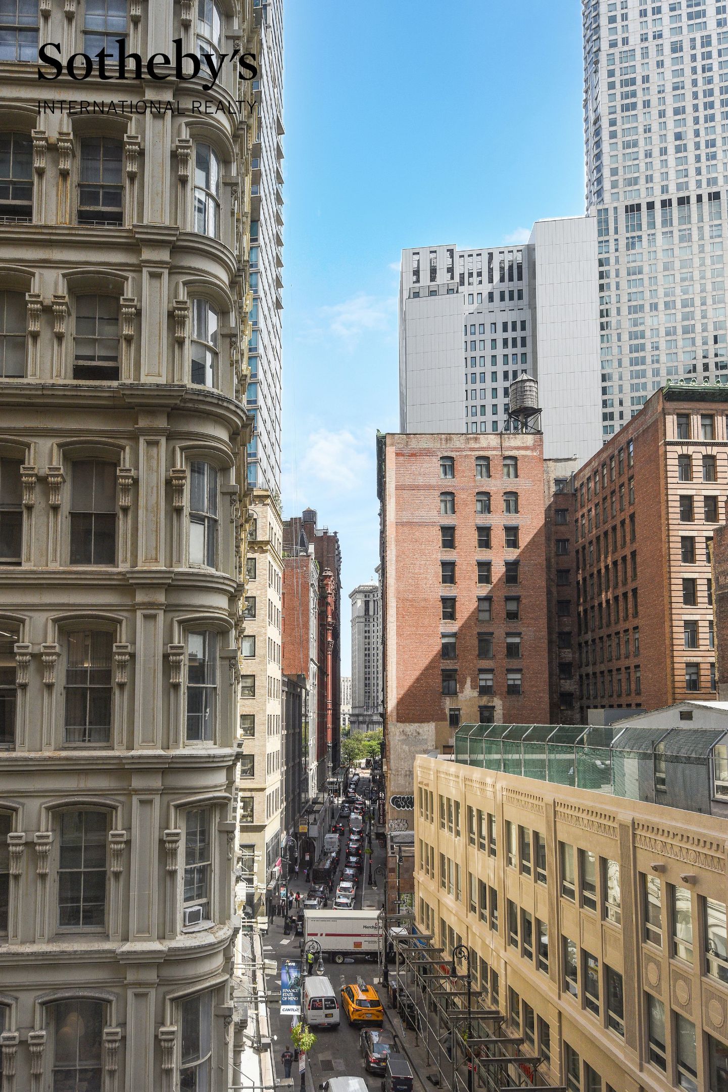 Downtown Manhattan street view framed by historic and modern buildings.
