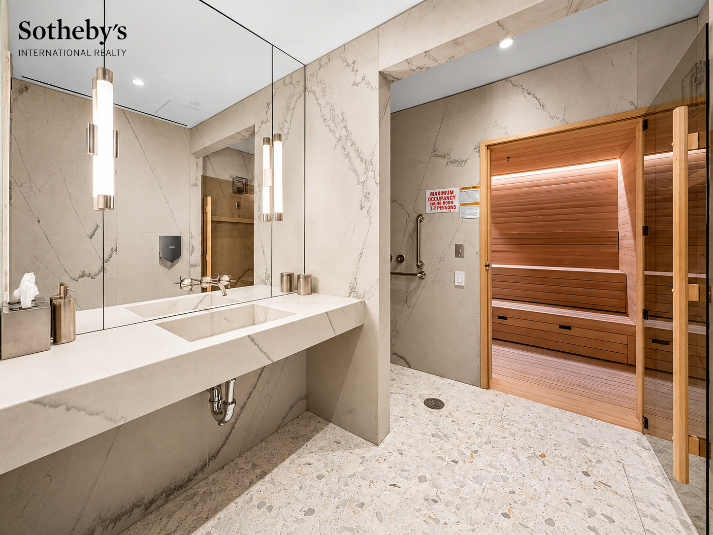 Marble bathroom vanity beside a wood-paneled sauna.