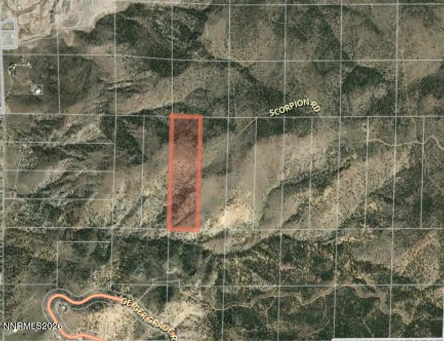 Aerial view of a red-outlined land parcel in rugged terrain near Scorpion Road and Geiger Grade Road.
