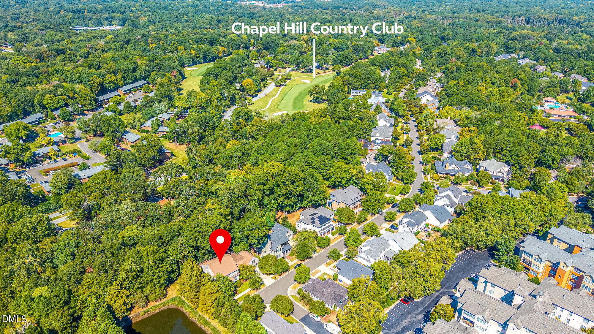 Aerial view of 1216 Pinehurst Drive, marked with a red pin near the Chapel Hill Country Club golf course.