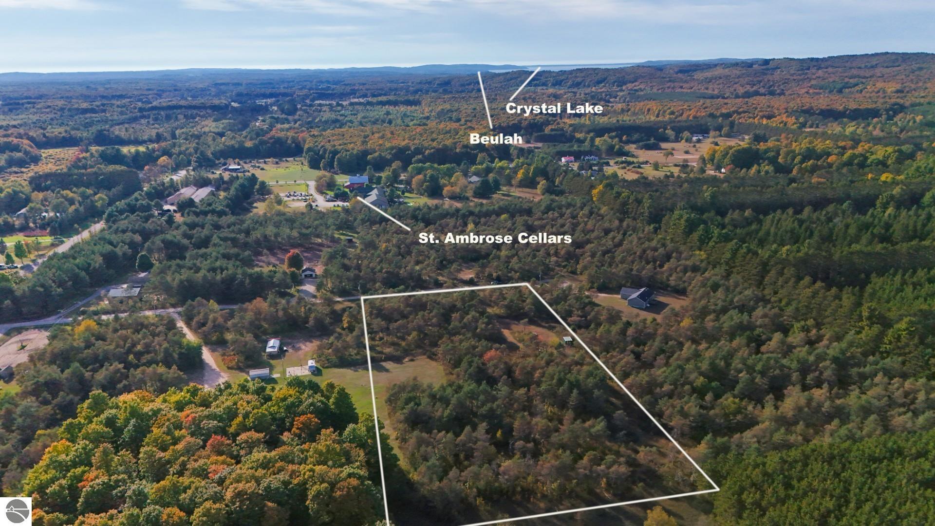 Aerial view of wooded vacant land outlined near Beulah, with colorful autumn foliage.