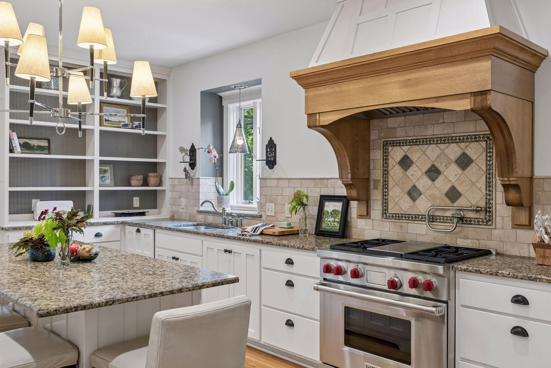 Kitchen with a carved wood range hood, decorative tile backsplash, and stainless steel range.