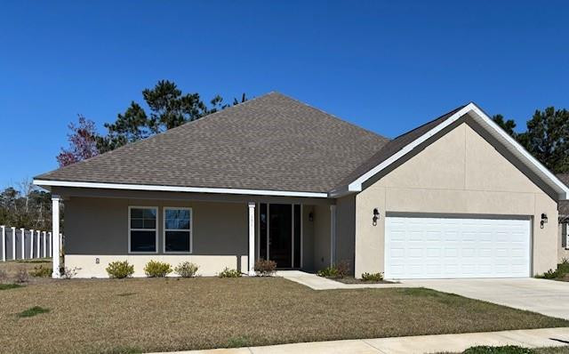 Single-story beige house with a white double garage door, covered entry, and broad front lawn.