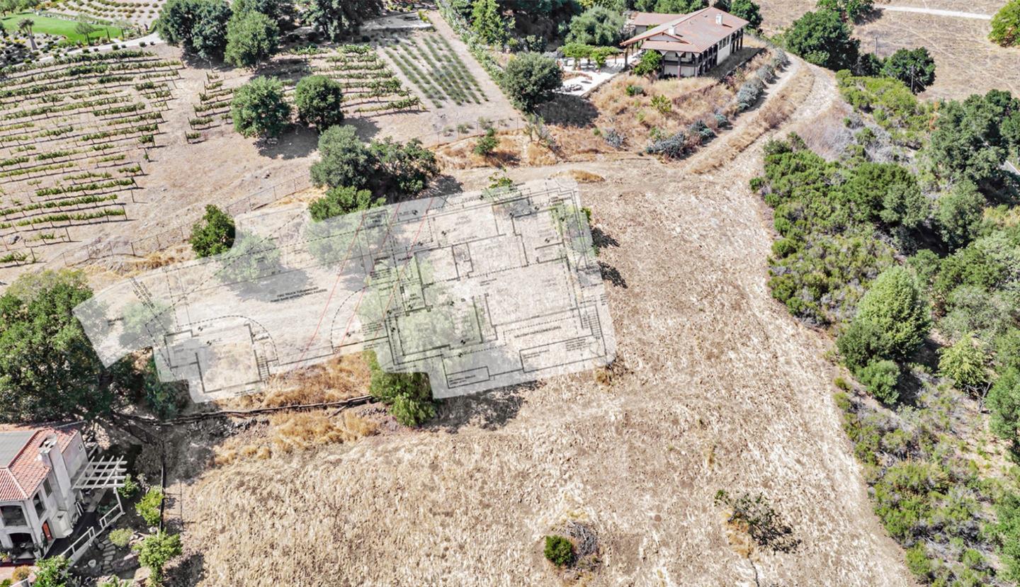 Aerial view of a dry property lot with a building-plan overlay and vineyard rows nearby.