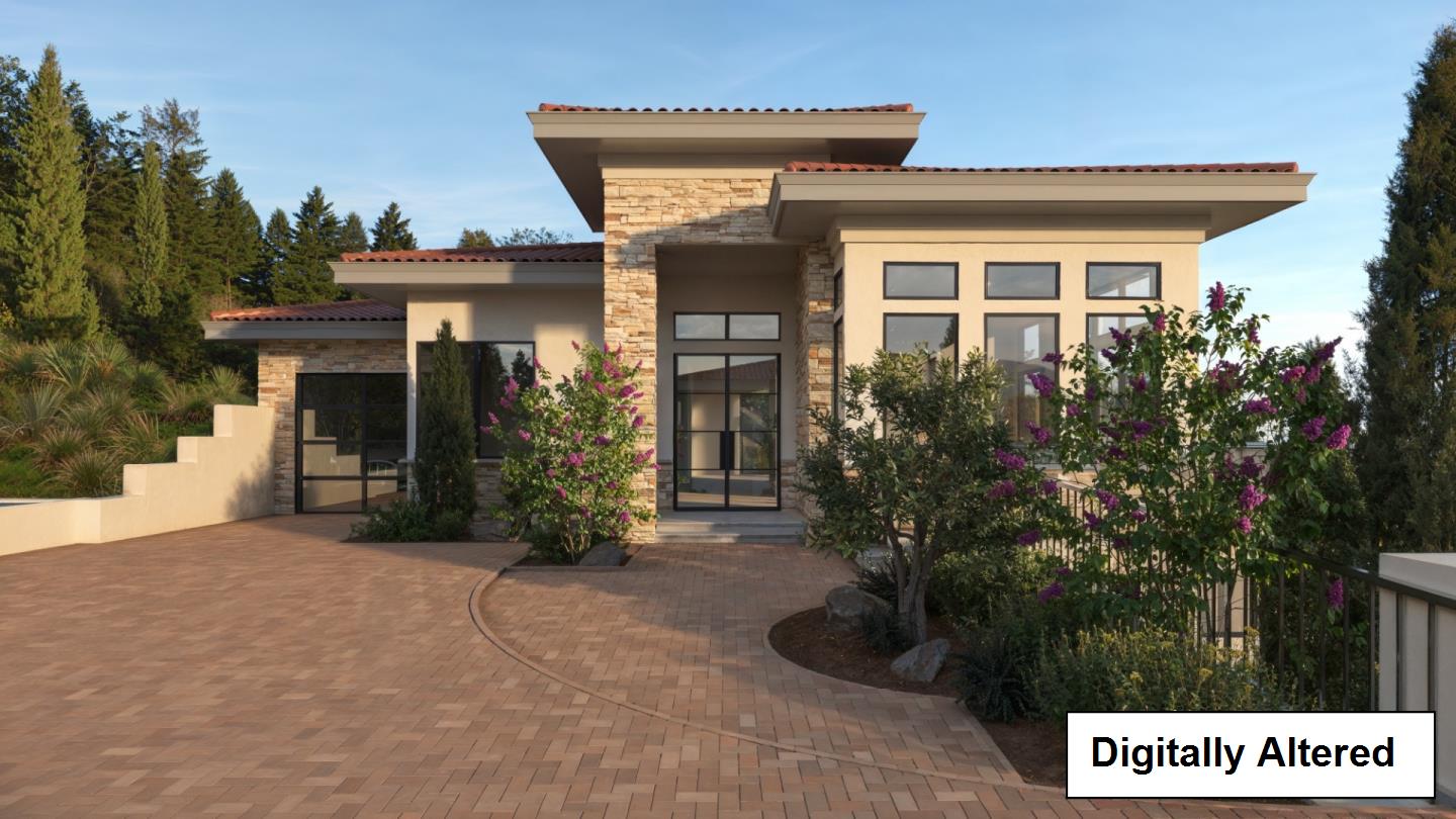 Modern home with stone accents, wide tiled rooflines, and a landscaped brick-paved courtyard.