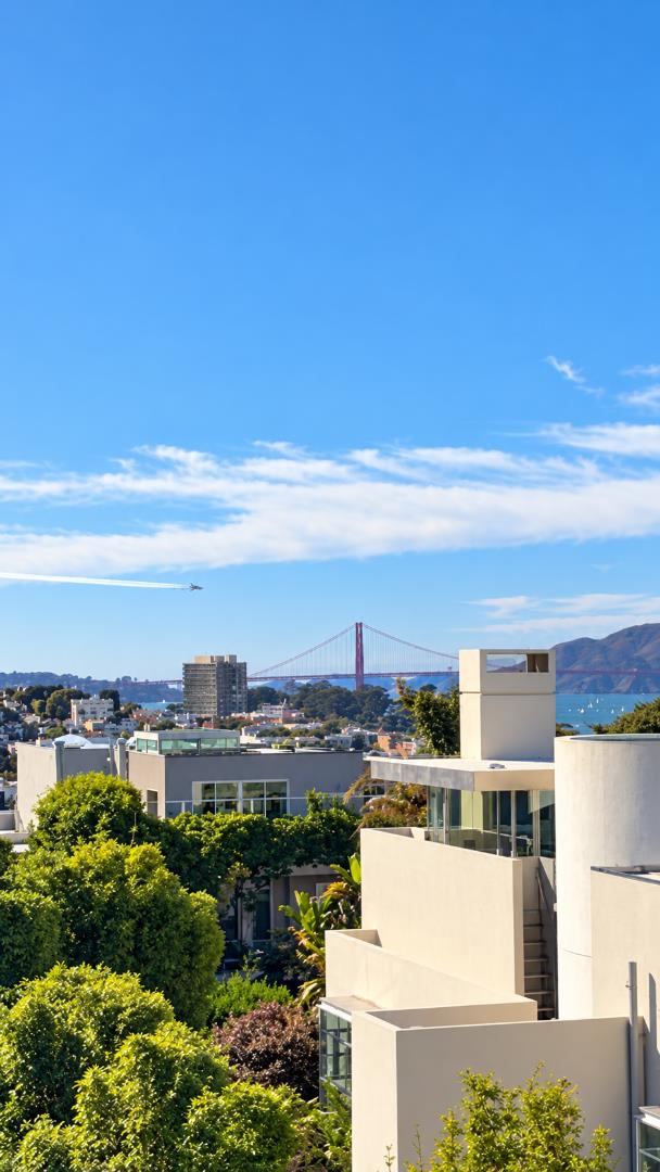 San Francisco residences with the Golden Gate Bridge and bay in the distance.