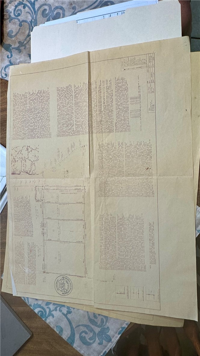 Property plat documents showing parcel boundaries, a small map, and printed legal descriptions.