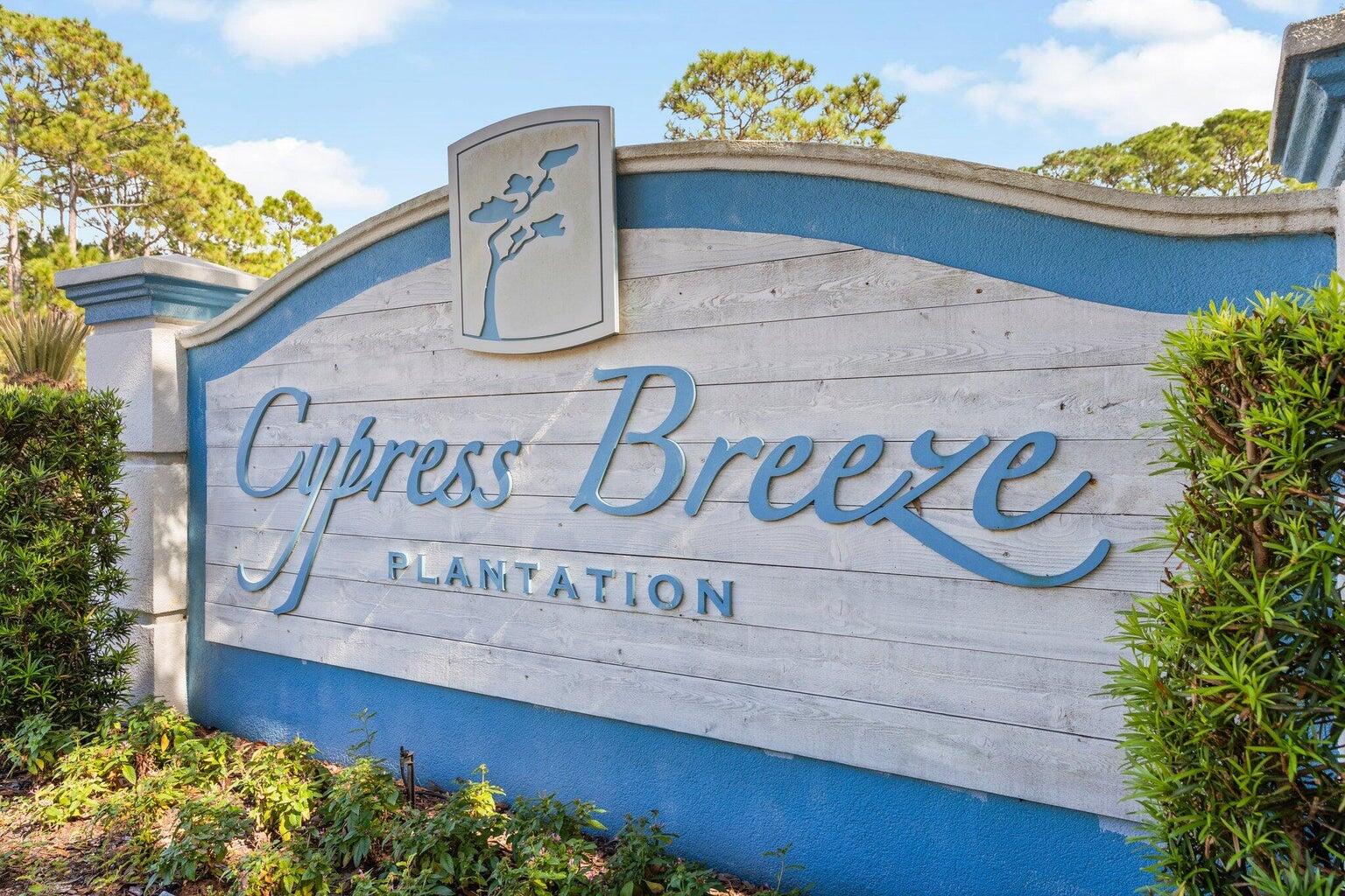 Cypress Breeze Plantation entrance sign framed by tropical landscaping.