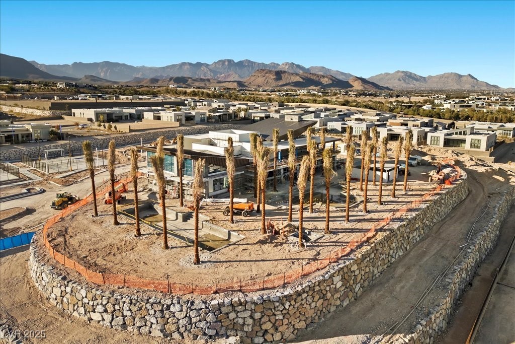 Home under construction, viewed from above, with new homes and mountains in the distance.
